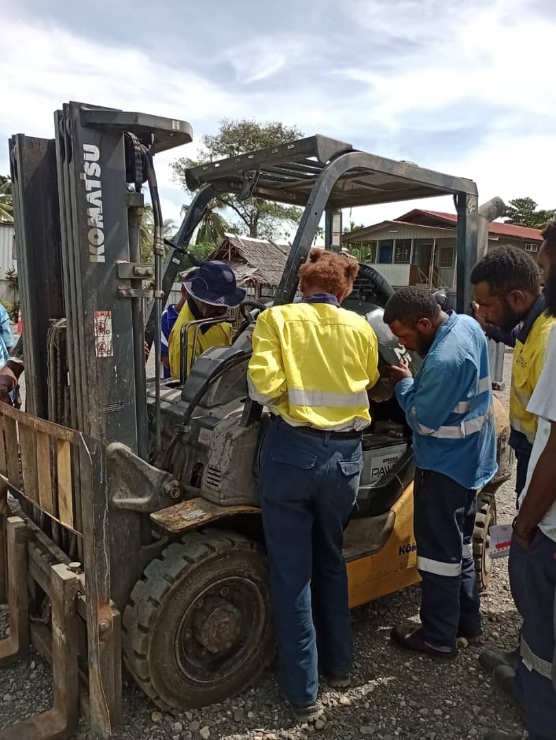 Heavy Equipment Fitting students inspecting a forklift engine
