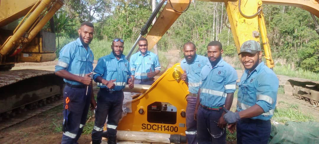 Heavy Equipment Fitting students servicing an excavator attachment on-site