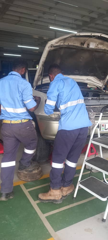 Motor Vehicle Mechanic students servicing a vehicle