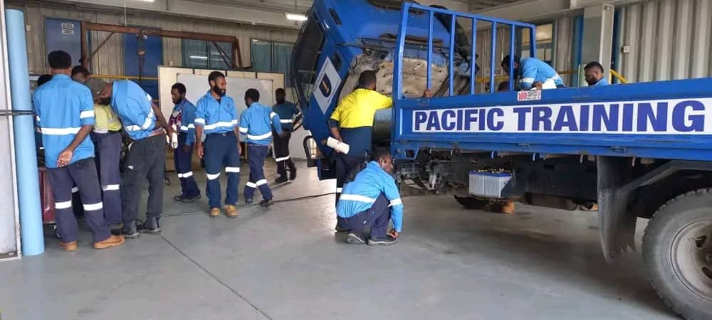 Students practicing welding and mechanical fitting